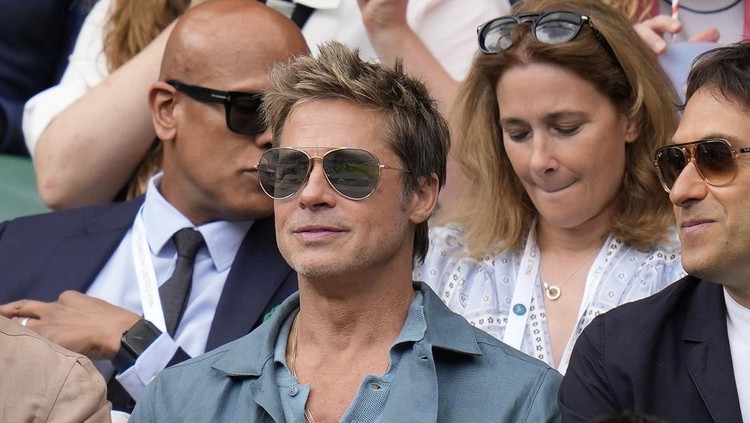 Actor Brad Pitt and director Guy Ritchie sit in the stands on Centre Court for the final of the men's singles between Spain's Carlos Alcaraz and Serbia's Novak Djokovic on day fourteen of the Wimbledon tennis championships in London, Sunday, July 16, 2023. (AP Photo/Kirsty Wigglesworth)