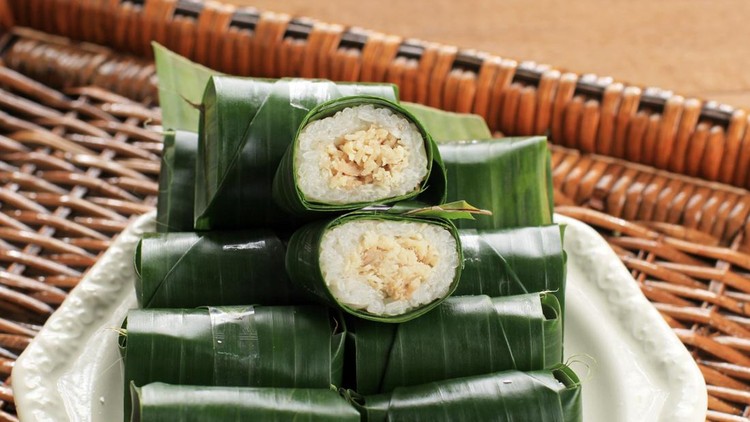 1461073517 Lemper is Indonesian Traditional Dish Made from Glutinous or Sticky Rice, Steamed with Coconut Milk, with Chicken Floss Inside and Wrapped with Banana Leaf.