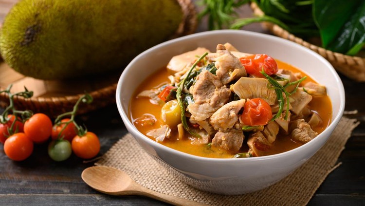 1310863029 Northern Thai food (Kang Kanoon), Spicy young jackfruit soup with pork in a bowl on wooden table