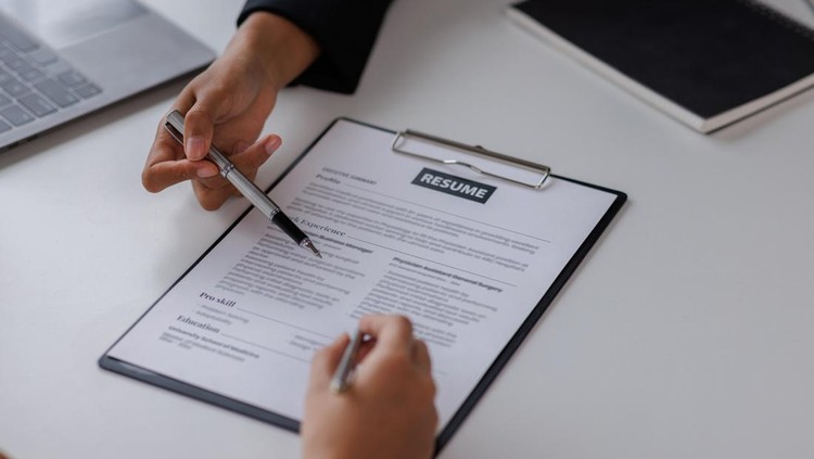 Examiner reading a resume during job interview at office Business and human resources concept.