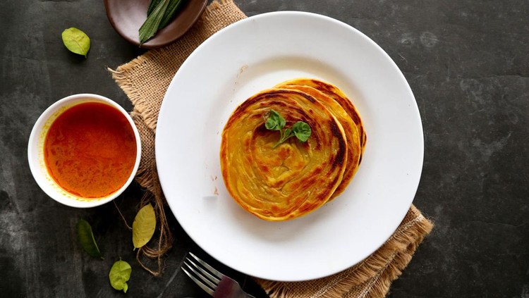 paratha bread or canai bread or roti maryam, favorite breakfast dish. served on plate