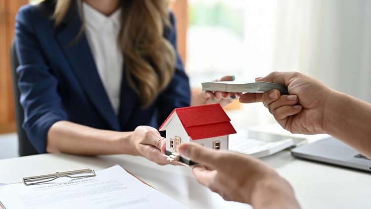 A female real estate agent receives a house loan payment or mortgage fees from her client. Property Investment concept. cropped