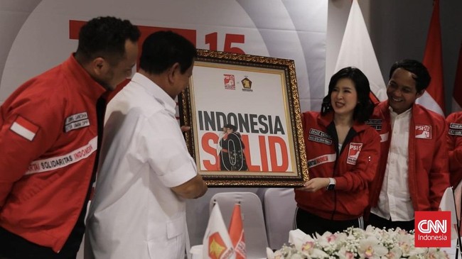 PSI memberikan bingkai foto atau lukisan yang memperlihatkan momen kebersamaan Jokowi dan Prabowo dengan latar belakang tulisan Indonesia Solid.