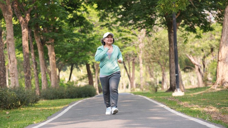 Healthy Lifestyle. Alone Senior Lady Exercising and Jogging in public garden
