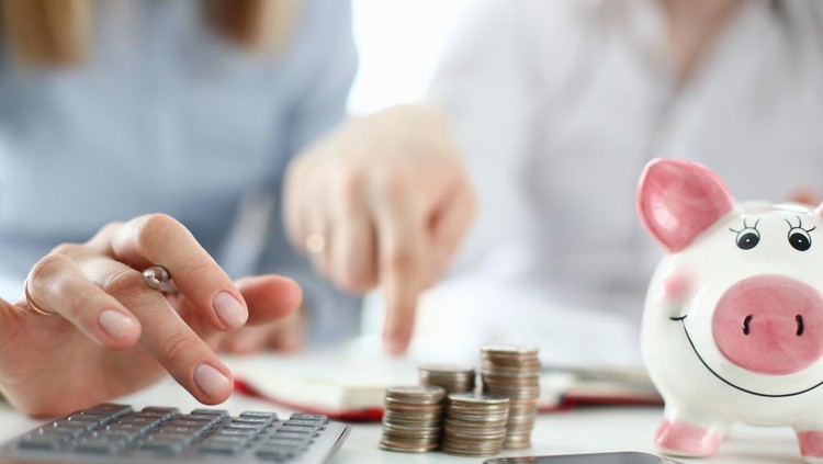 Man and woman hand consider on calculator expenses of family budget aganist home background. Lending purchase rental housing mortgage concept