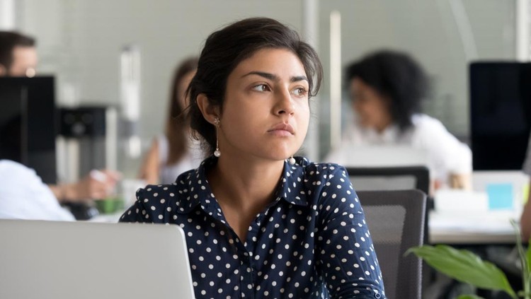 1070271670 Thoughtful indian business woman looking away feeling bored pensive thinking of problem solution in office with laptop, serious hindu employee searching new ideas at work unmotivated about dull job