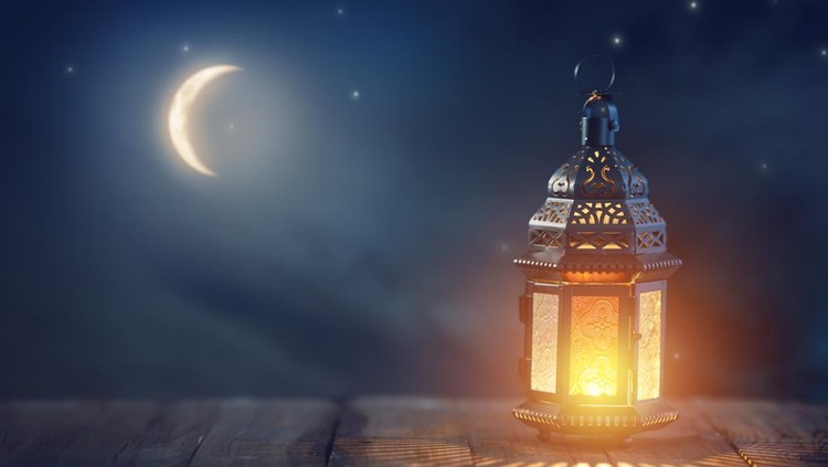Ornamental Arabic lantern with burning candle glowing at night. Festive greeting card, invitation for Muslim holy month Ramadan Kareem.