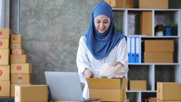 1428395180 Woman online store small business owner seller entrepreneur packing package post shipping box preparing delivery parcel on table. Ecommerce drop shipping shipment service concept.