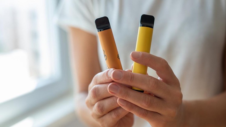 Electronic cigarette in a woman's hand