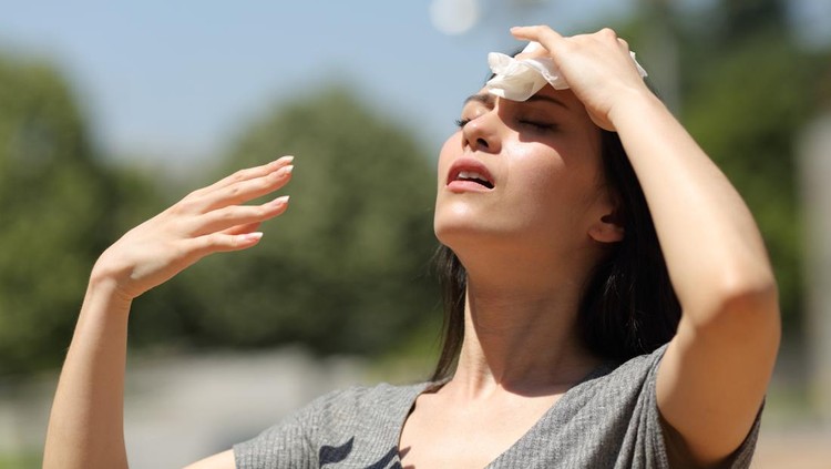 Asian woman drying sweat in a warm summer day