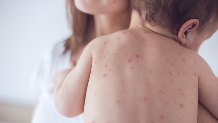 Mother nursing sick child At Home