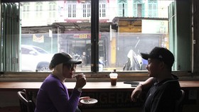 Suasana pengunjung berdiskusi sambil menikmati minuman kopi di kedai Kopi Apek di Medan, Sumatera Utara, Sabtu (07/10/2023). Kopi Apek yang berdiri sejak 1919 tersebut menjadi kedai kopi legendaris di Medan yang diminati wisatawan lokal maupun mancan
