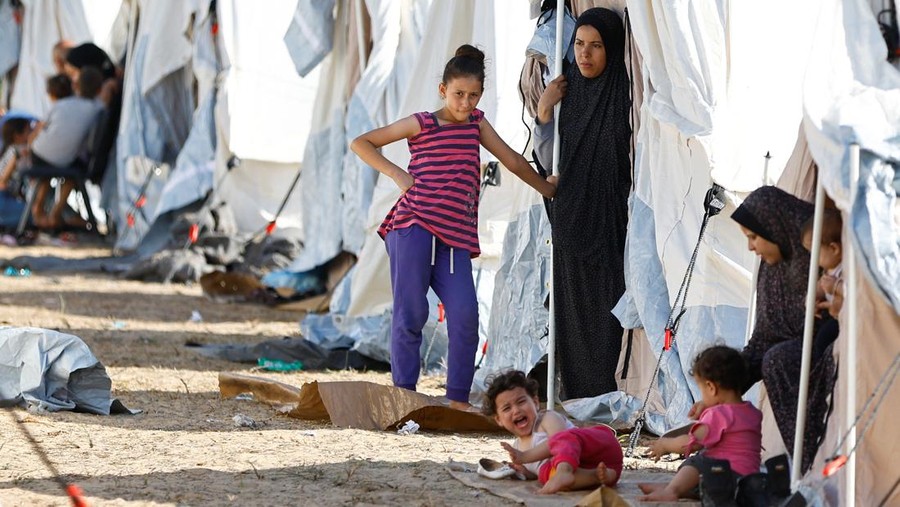 Palestinians, who fled their houses amid Israeli strikes, take shelter in a tent camp at a United Nations-run centre, after Israel's call for more than 1 million civilians in northern Gaza to move south, in Khan Younis in the southern Gaza Strip, October 19, 2023. REUTERS/Ibraheem Abu Mustafa