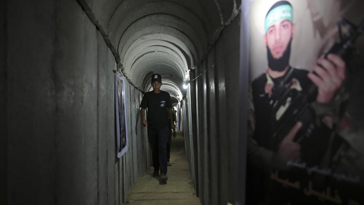 FILE - A Palestinian youth walks inside a tunnel used for military exercises during a weapon exhibition at a Hamas-run youth summer camp in Gaza City July 20, 2016. An extensive labyrinth of tunnels built by Hamas stretches across the dense neighborhoods of the Gaza Strip, hiding militants, their missile arsenal and the over 200 hostages they now hold after an unprecedented Oct. 7, 2023, attack on Israel. (AP Photo/Adel Hana, File)