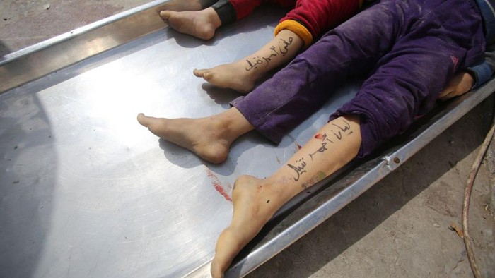 EDITORS NOTE: Graphic content / TOPSHOT - The bodies of children from the Nateel family, with their names Hani (L) and Layan written on their legs by their parents to help in identification, lie in the morgue of a hospital in Deir el-Balah following an Israeli air strike on the central Gaza Strip on October 22, 2023, amid ongoing battles between Israel and the Palestinian Hamas movement. (Photo by Bashar TALEB / AFP) (Photo by BASHAR TALEB/AFP via Getty Images)