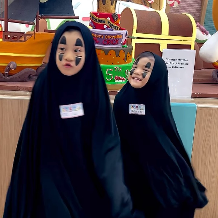 <p>Kedua anak Putri Titian, Theodore Iori Liem dan Mykah Iago Liem, turut merayakan halloween dengan mengenakan kostum Kaonashi yang dibuat sendiri, Bunda. "Bermodalkan bergo oma yang bau minyak angin ama eyeliner Momom dan nego alot sama anak-anak akhirnya mereka cosplay jadi no face karakter di film <em>Spirited Away</em> asalkan mukanya ga di putihin ceunaah," cerita Putri. (Foto: Instagram: @putrititian)</p>