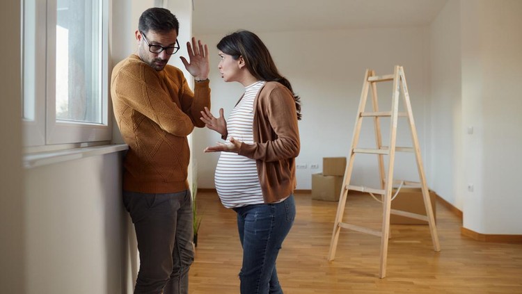 Displeased expecting couple having problems after moving into a new apartment. Copy space.