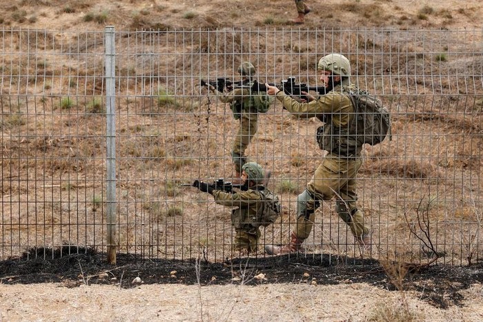 Israeli soldiers scan an area while sirens sound as rockets from Gaza are launched towards Israel,, near Sderot, southern Israel, October 9, 2023. REUTERS/Amir Cohen Acquire Licensing Rights