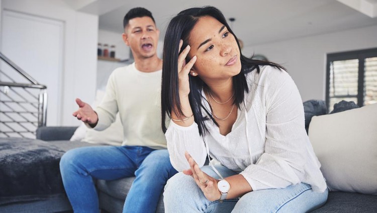 Frustrated couple, headache and argument in divorce, conflict or disagreement on living room sofa at home. Unhappy man and woman in breakup, cheating affair or fight from toxic relationship in house