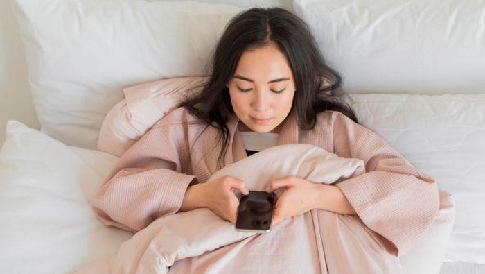 Ilustrasi Perempuan sedang Memainkan Smartphone/Foto: Freepik/Freepik