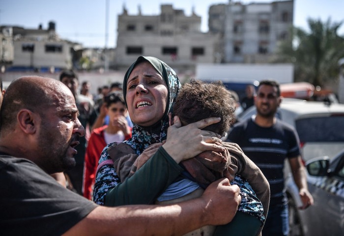 GAZA CITY, GAZA - OCTOBER 26: A woman holds his 3 year-old son, Ekrem Salih Abu Shemale who died after the Israeli airstrikes that continues in Gaza City, Gaza on October 26, 2023. (Photo by Abed Zagout/Anadolu via Getty Images)