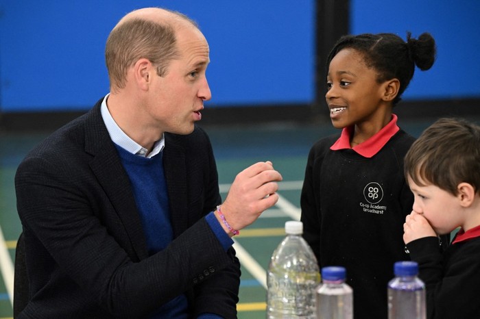 Britain's Prince William, Prince of Wales speaks with children during a visit of the Millennium Powerhouse, a multi-service youth hub which works with a wide range of local organisations with a mission to create brighter futures for young people, in Moss Side neighbourhood, in Manchester, on November 16, 2023. (Photo by Oli SCARFF / POOL / AFP)