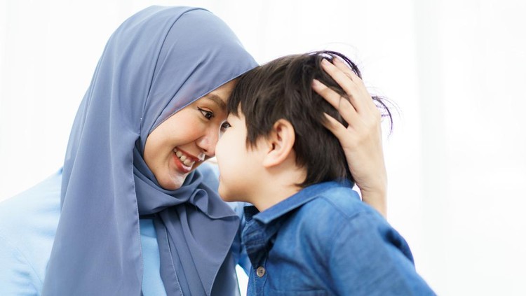 1498840224 Happy cheerful Asian muslim family stay together in living room in weekend, Beautiful Asian woman muslim and lovely little boy portrait and looking at camera.