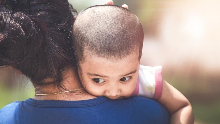 Indian mother carrying her baby daughter, selective focus.
