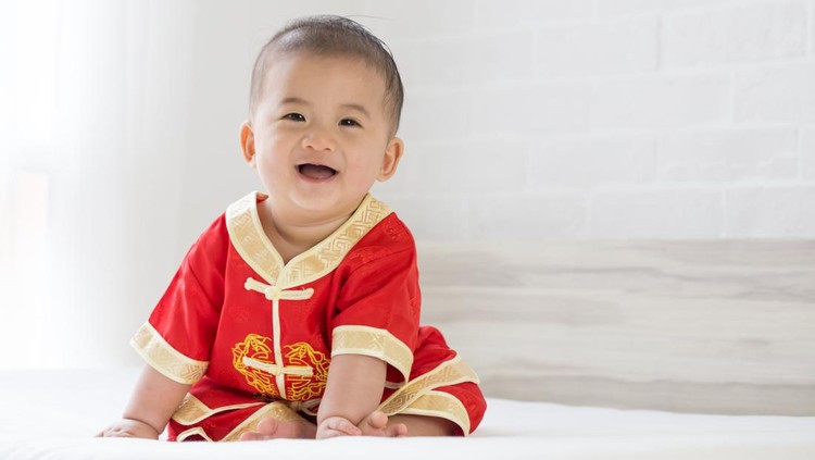 Asian baby boy smiling with traditional Chinese outfit. Dress up for Chinese new year festival concept