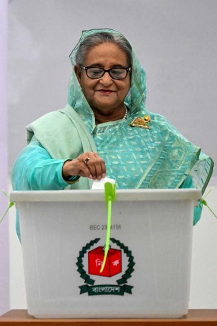 Bangladesh's Prime Minister Sheikh Hasina casts her vote at a polling station in Dhaka on January 7, 2024. Bangladesh began voting on January 7, in an election guaranteed to give a fifth term in office to Prime Minister Sheikh Hasina, after a boycott led by an opposition party she branded a 