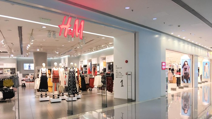 Guangzhou, China - May 10, 2016: One HM Store and  one Uniqlo Store in Guangzhou seen from the outside in Zhujiang new town(downtown Guangzhou).Uniqlo is a Japanese maker, and  HM is a Sweden one of mostly casual clothing.