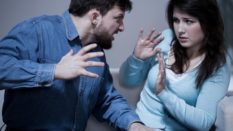 Angry aggressive husband trying to hit his wife