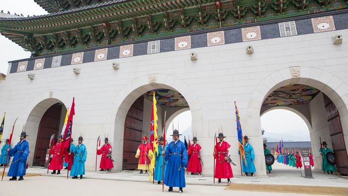 Seoul, South Korea - Aug 8, 2013: Korean Royal guards perform the changing of the guard ceremony at Gwanghwamun, Gyeongbokgung Palace, Seoul, South Korea. The ceremony started in the 14th century and has been well preserved and is now shown to the tourists several times a day.