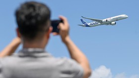 An Airbus A350-1000 airplane flies past during the Singapore Airshow in Singapore on February 20, 2024. (Photo by Roslan RAHMAN / AFP)