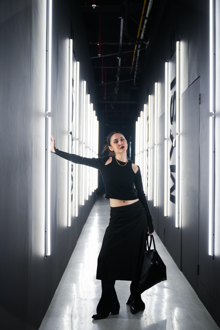 Outfit edgy bisa didapatkan dengan susunan fashion items cukup sederhana. Atasan cutout di bagian pundak yang beri kesan halter neck, berpadu midi skirt yang menumpuk loose pants. Tambahkan chain necklace untuk menguatkan gaya/ Foto: Courtesy of YSL