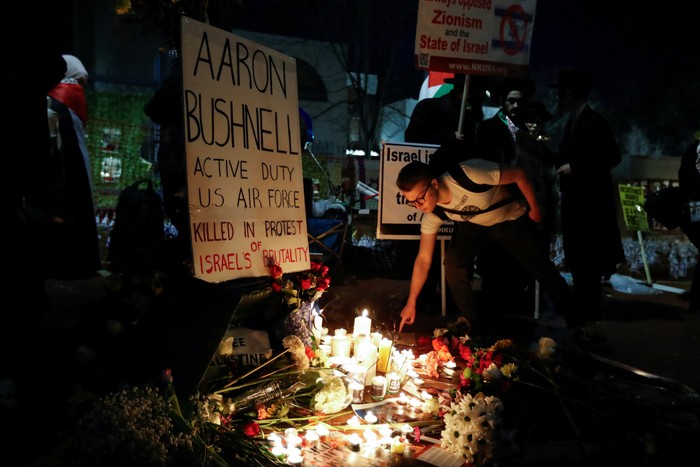 People attend a vigil for U.S. Airman Aaron Bushnell, who died after setting himself on fire in front of the Israeli Embassy in Washington on February 25 in an apparent act of protest against the war in Gaza between Israel and the Palestinian Islamist group Hamas, in Washington, D.C., U.S., February 26, 2024. REUTERS/Allison Bailey