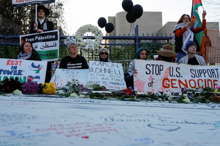 People attend a vigil for U.S. Airman Aaron Bushnell, who died after setting himself on fire in front of the Israeli Embassy in Washington on February 25 in an apparent act of protest against the war in Gaza between Israel and the Palestinian Islamist group Hamas, in Washington, D.C., U.S., February 26, 2024. REUTERS/Allison Bailey
