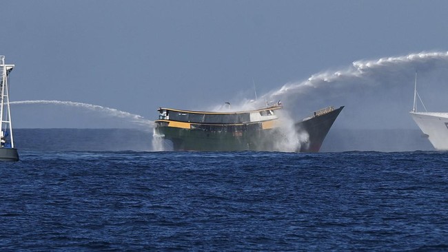 This photo taken on March 5, 2024 shows China Coast Guard vessels deploying water cannons at the Philippine military chartered Unaizah May 4 (C) during its supply mission to Second Thomas Shoal in the disputed South China Sea. The Philippines said on