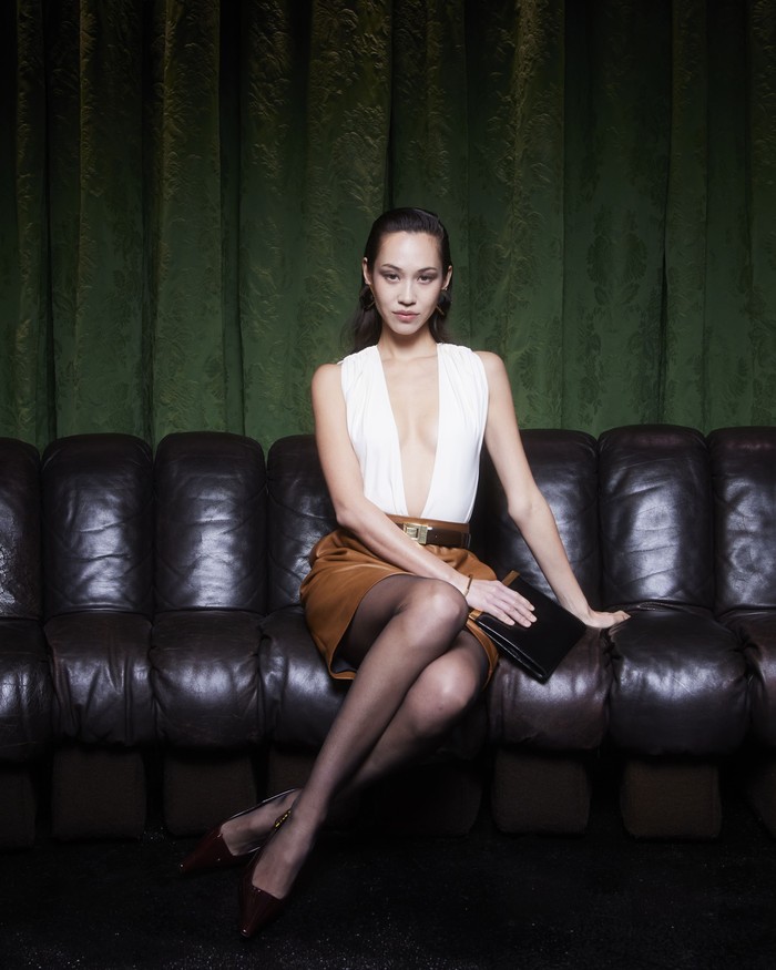 Dressed in a low cut top and brown skirt, Kiko Mizuhara managed to create a statement look that is characteristic of Saint Laurent / Photo: Courtesy of Saint Laurent
