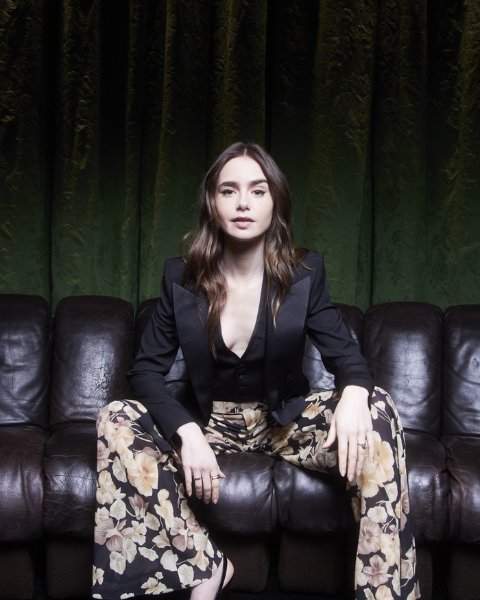 Lily Collins appeared at the fashion show with an androgynous style.  The tailored blazer & vest combination is even more interesting when paired with floral pants as a feminine touch/ Photo: Courtesy of Saint Laurent