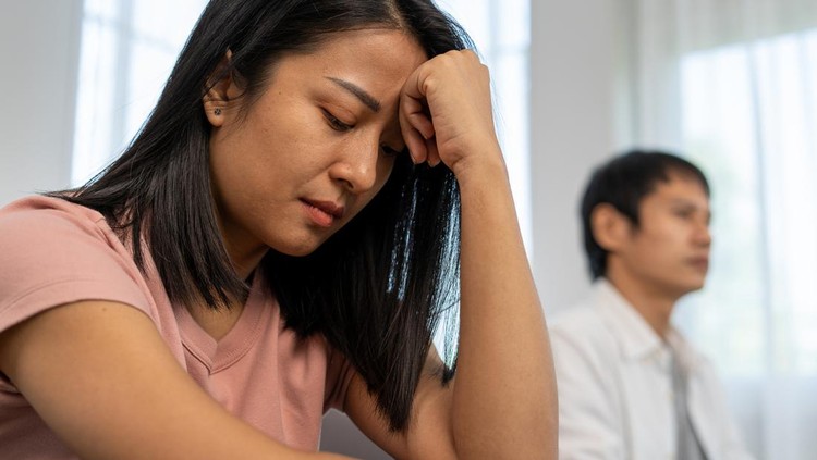Asian women are disappointed and saddened after an argument with their husband. Asian couples are having family problems resulting in divorce. Love problem