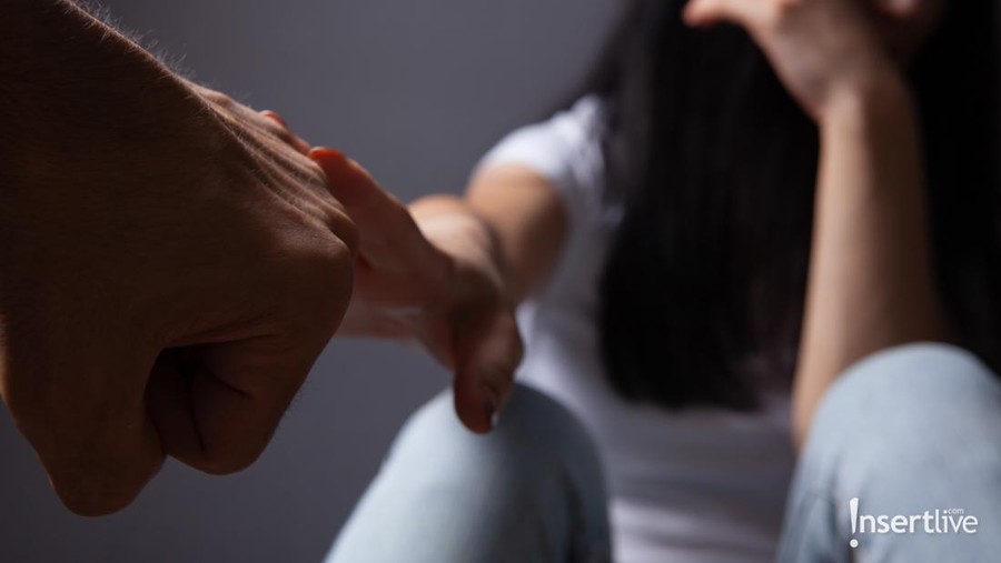 Beaten young woman sitting on a chair