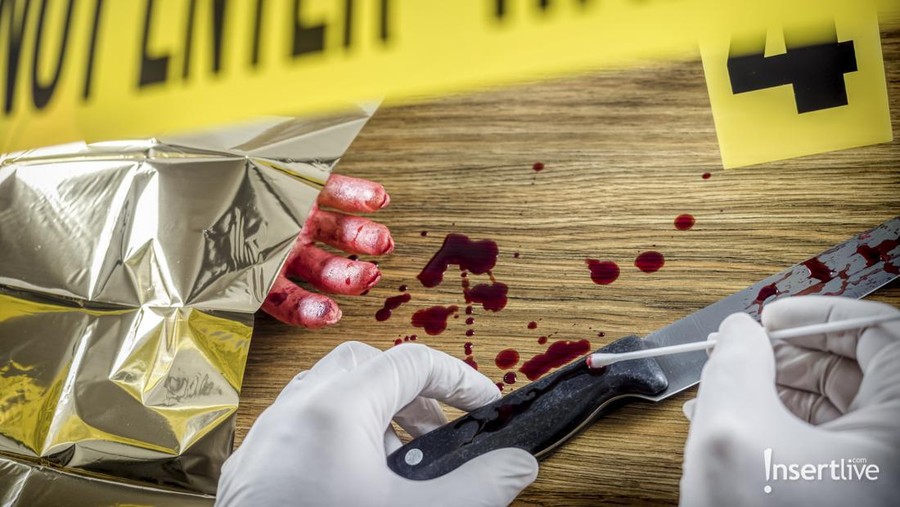 Human corpse covered with a sheet and name tag on toe in the morgue
