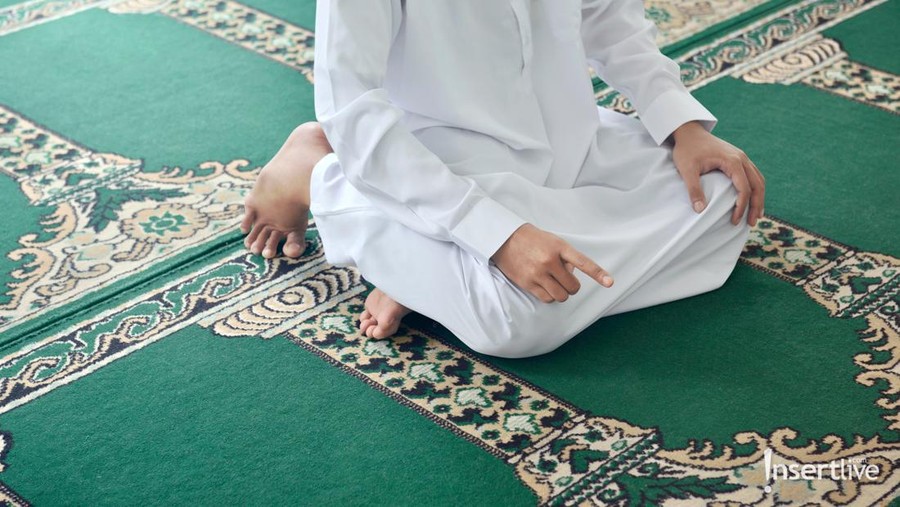 Religious muslim man praying inside the mosque