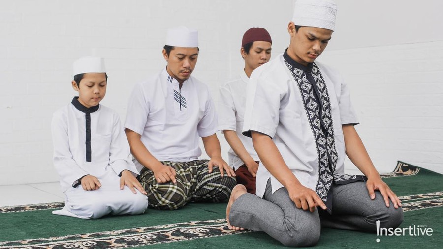 Religious muslim man praying inside the mosque