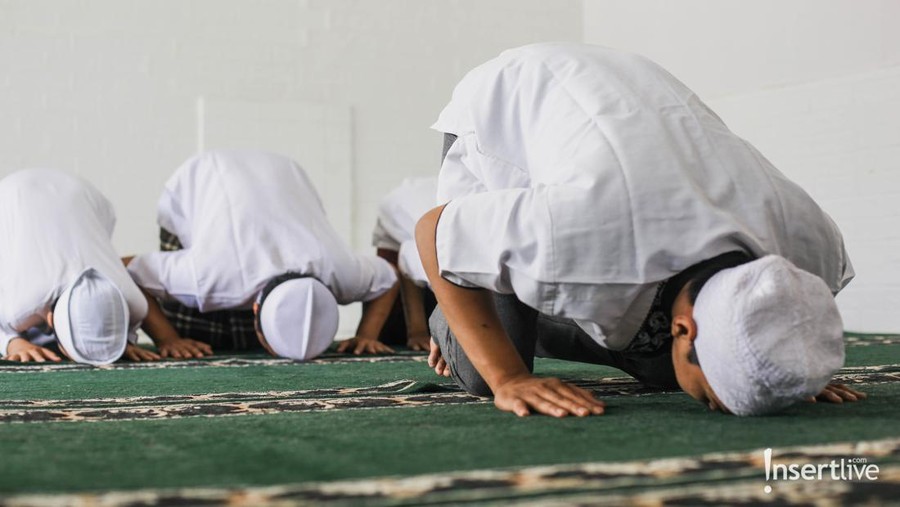 Religious muslim man praying inside the mosque