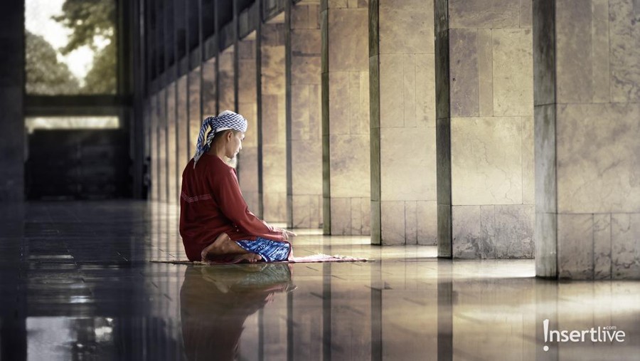 Religious muslim man praying inside the mosque