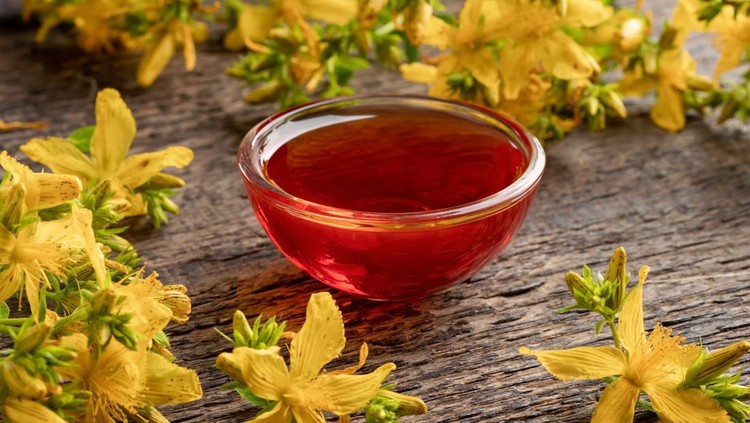 A bowl of red oil made from St. John's wort flowers