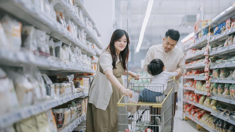 young Asian Chinese family buying groceries in supermarket refrigerated section