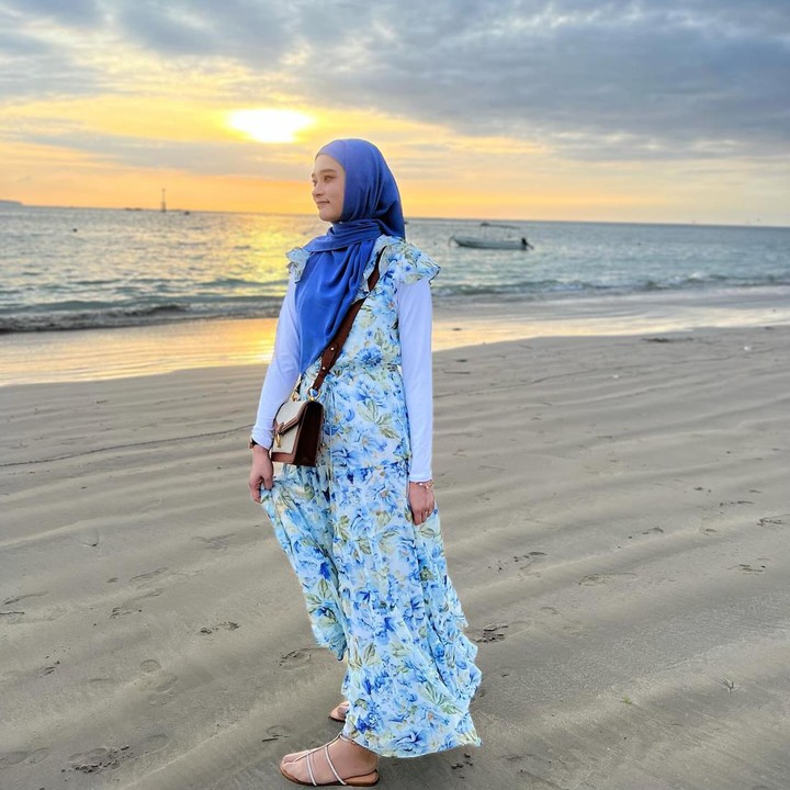 <p>Inara Rusli juga gemar mengenakan busana yang bernuansa <em>colorful.</em> Seperti dengan memakai gamis bercorak bunga dan alas kaki <em>strappy shoes</em> untuk gaya pergi ke pantai. (Foto: Instagram @mommy_starla)</p>